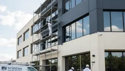 Professional commercial painters working on an office exterior in Lancaster, PA