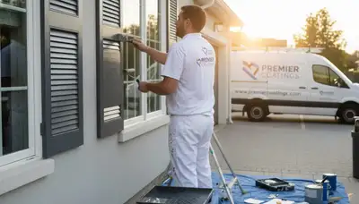 Professional painters refinishing exterior shutters on a Lancaster PA home for durable weather protection